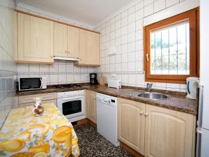 a kitchen with a table with a vase on it at Holiday Home Casa Lina by Interhome in Calpe