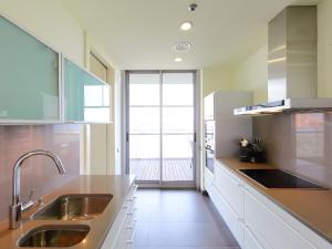 a kitchen with a sink and a large window at Apartment Diagonal Mar by Interhome in Barcelona