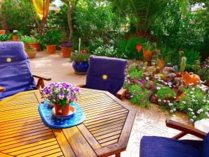 a patio with a table and chairs and flowers at Holiday Home B&B by Interhome in Calpe