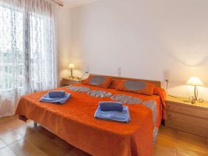 a bedroom with a bed with two towels on it at Holiday Home Eva by Interhome in Sant Antoni de Calonge