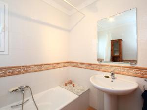 a white bathroom with a sink and a mirror at Holiday Home Pla del Mar by Interhome in Moraira +7 photos