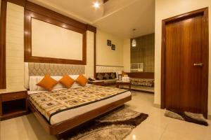 Postel nebo postele na pokoji v ubytování Hotel Aster Inn New Delhi