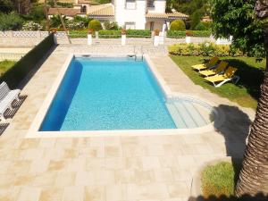an overhead view of a swimming pool with lounge chairs at Holiday Home Eva by Interhome in Sant Antoni de Calonge