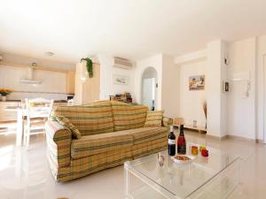 a living room with a couch and a glass table at Apartment Cascadas de la Marina-3 by Interhome in Denia