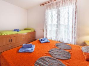 a bedroom with a bed with two blue towels on it at Holiday Home Eva by Interhome in Sant Antoni de Calonge +6 photos