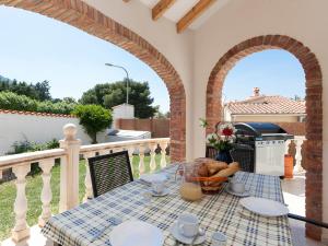 a table on a balcony with a grill at Holiday Home Tossal Gros by Interhome in Denia