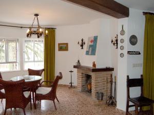 a dining room with a table and a fireplace at Holiday Home Pia by Interhome in Denia