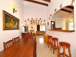 a living room with a table and some chairs at Holiday Home La Sabatera by Interhome in Moraira