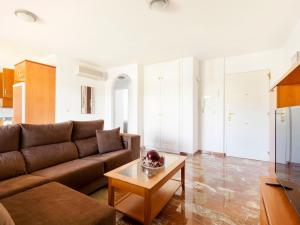 a living room with a couch and a coffee table at Apartment Cascadas de la Marina-2 by Interhome in Denia