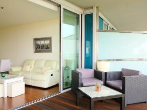 a living room with a couch and a table at Apartment Diagonal Mar by Interhome in Barcelona