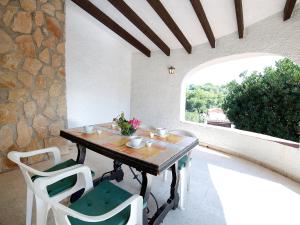 a table and chairs on a patio with a window at Villa Halibut by Interhome in Fanadix