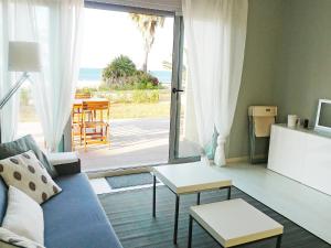 a living room with a couch and a view of the ocean at Apartment Marenia by Interhome in Denia