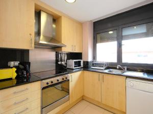 a kitchen with a sink and a stove top oven at Apartment Tramuntana by Interhome in Lloret de Mar