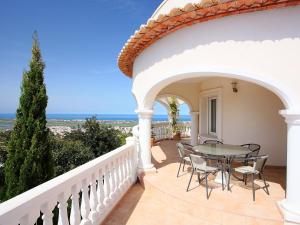 a patio with a table and chairs on a balcony at Villa Puesta del Sol by Interhome in Monte Pego