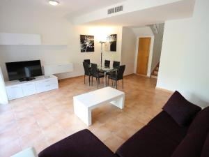 a living room with a couch and a table with chairs at Holiday Home Zona Estival-2 by Interhome in Salou