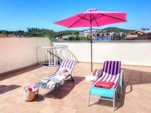 two chairs and an umbrella on a roof at Apartment Tramuntana by Interhome in Lloret de Mar