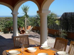 a table with plates and wine glasses on a porch at Villa Villa Corona by Interhome in Beniarbeig