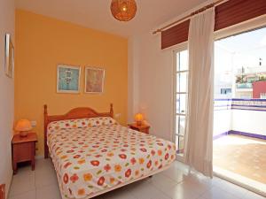 a bedroom with a bed and a large window at Apartment San Luis Playa by Interhome in Rincón de la Victoria