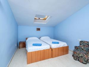a small bedroom with a bed and a chair at Apartment Menorca-3 by Interhome in Balcon del Mar