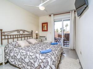 a bedroom with a bed and a balcony at Apartment Sorolla-1 by Interhome in Jávea