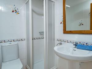 a bathroom with a sink and a toilet and a mirror at Apartment Menorca-3 by Interhome in Balcon del Mar +16 photos