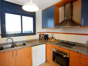 a kitchen with a sink and a stove at Holiday Home Peiro by Interhome in L'Ampolla +9 photos