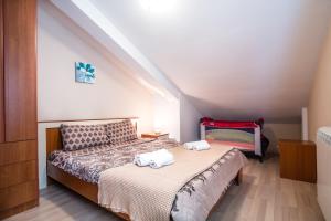 a bedroom with a bed with two towels on it at Apartments Radonjić in Kotor