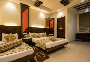 Postel nebo postele na pokoji v ubytování Hotel Aster Inn New Delhi