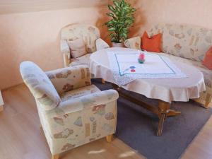 a living room with a table and two chairs at Apartment Bentweg by Interhome in Altgaude