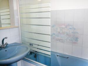 uma casa de banho com um lavatório e uma cabina de duche em vidro. em Apartment La Plage Dorée by Interhome em Bandol