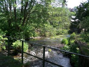 a river with a fence next to a river with trees at Holiday Home Vielsalm by Interhome in Vielsalm