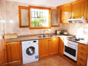 a kitchen with a washing machine and a sink at Holiday Home Gabi by Interhome in Monte Pego