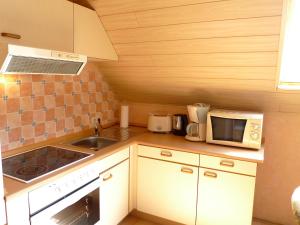 a small kitchen with a sink and a microwave at Apartment Bentweg by Interhome in Altgaude