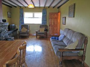a living room with a couch and a table at Holiday Home Seaside Cottages-2 in Valentia Island