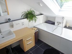 a bathroom with a sink and a bath tub at Apartment Weisenhorn by Interhome in Bötzingen
