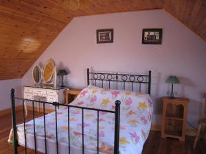 a bedroom with a bed in a attic at Holiday Home Seaside Cottages-1 in Valentia Island
