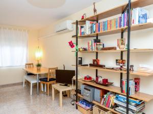 a room with a desk and a shelf with books at Apartment Camp Nou- Travessera de les Corts by Interhome in Barcelona