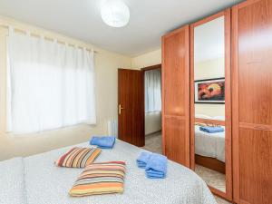 a bedroom with a bed with two pillows on it at Apartment Camp Nou- Travessera de les Corts by Interhome in Barcelona