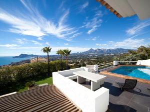 a villa with a pool and a view of the ocean at Villa Palm Spring by Interhome in Altea la Vieja