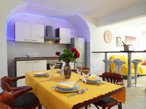 a dining room table with a yellow table cloth on it at Apartment Andrea by Interhome in Opatija