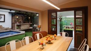 a dining room with a table and a swimming pool at Casa García in Guayaquil