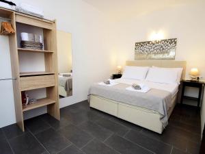 a small bedroom with a bed and a refrigerator at Apartment Molo Lozna-2 by Interhome in Postira +4 photos