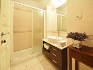a bathroom with a sink and a shower at Apartment Deni-1 by Interhome in Volosko +16 photos