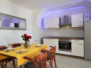 a kitchen with a table with a yellow table cloth at Apartment Andrea by Interhome in Opatija