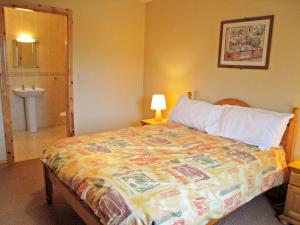 a hotel room with a bed and a bathroom at Holiday Home Ardgroom-1 by Interhome in Ardgroom