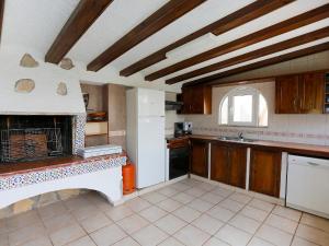 a kitchen with a fireplace in the middle of it at Villa Maria Cristina by Interhome in Miami Platja