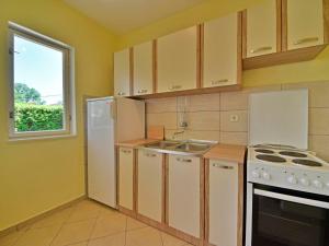 a kitchen with a white refrigerator and a sink at Holiday Home Franjo-2 by Interhome in Ika +16 photos