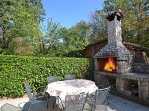 a table and chairs and a fireplace in a yard at Holiday Home Jelka by Interhome in Njivice