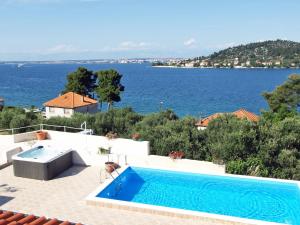 a swimming pool with a view of the water at Apartment Zdenko-5 by Interhome in Kali