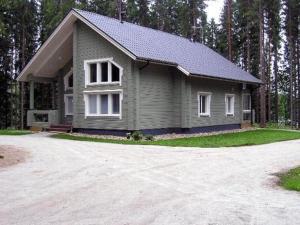 a small house with a driveway in front of it at Holiday Home Kärkelä by Interhome in Sulkava